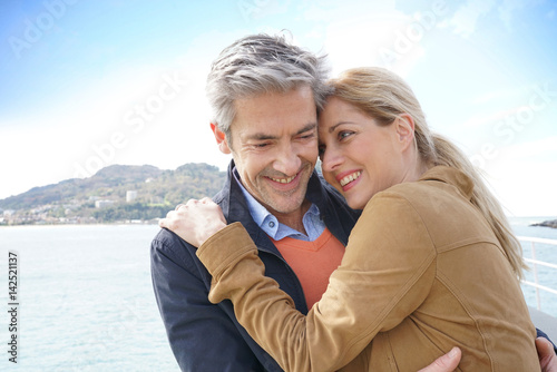 Middle-aged couple embracing each other by the sea, San Sebastian
