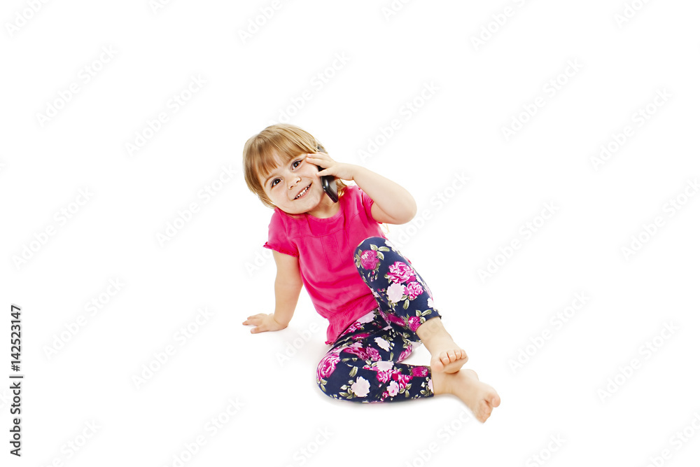 Happy baby girl talking on mobile. Isolated on white background
Happy baby girl talking on mobile. Isolated on white background