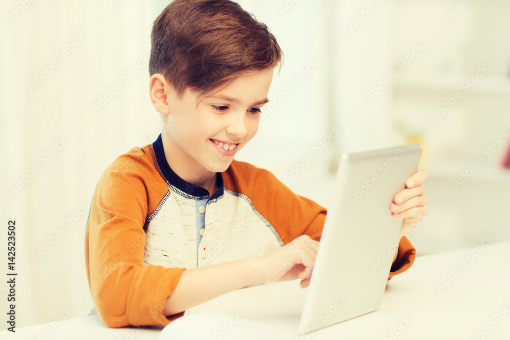smiling boy with tablet pc computer at home smiling boy with tablet pc computer at home
