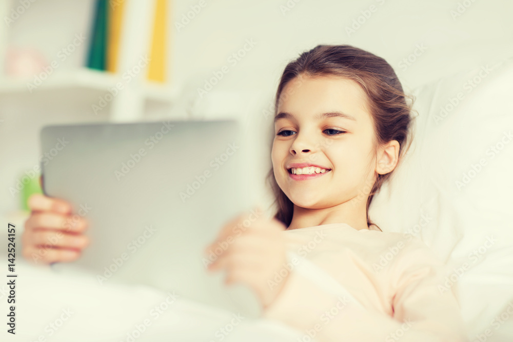 happy girl lying in bed with tablet pc at home happy girl lying in bed with tablet pc at home