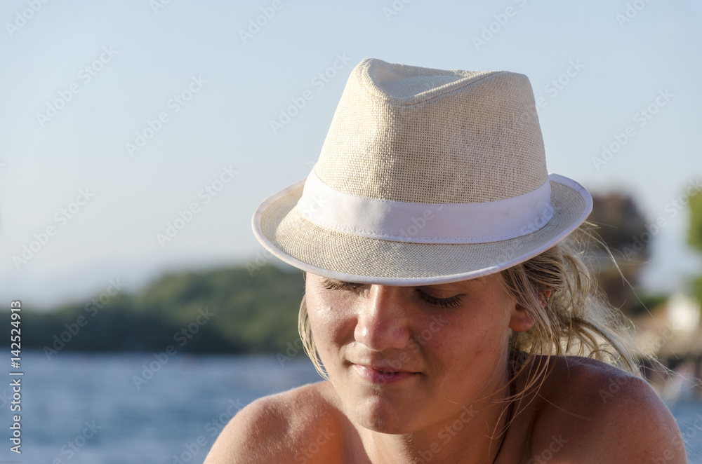 Portrait of pretty summer thoughtful girl in love with straw hat