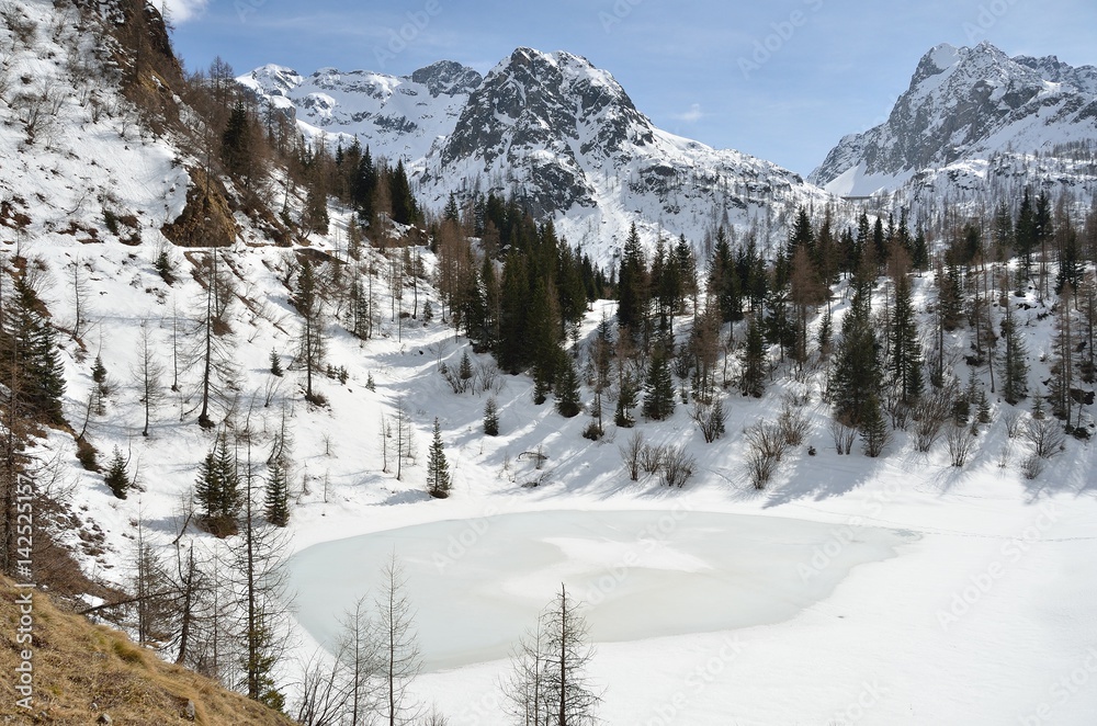 Frozen lake in the mountains, Alps, Italy
