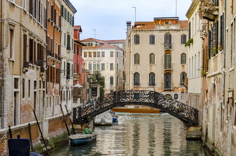 one of the many canals, bridge and typical house architecture style of Venice, Italy