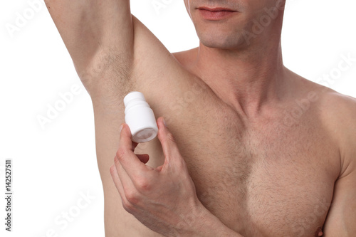 Man applying deodorant on armpit . Male putting antiperspirant stick on underarms