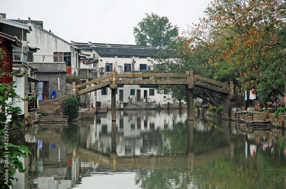 China, Shanghai water village Tongli. typical village canal with an old bridge.