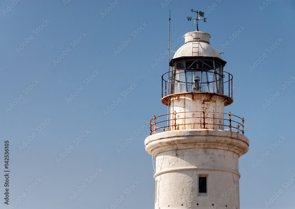 White lighthouse with weathervane White lighthouse with weathervane
