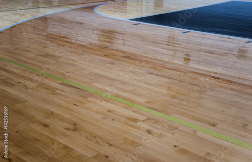 Lines green and blue with newly refinished wood gym floors