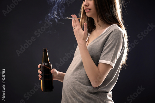 Pregnant woman smoking ciga...