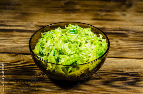 Salad with savoy cabbage and green onion in a bowl