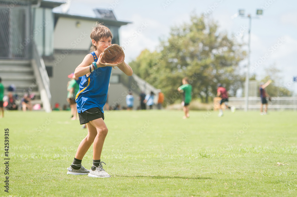 young preteen boy playing softball on outdoor background