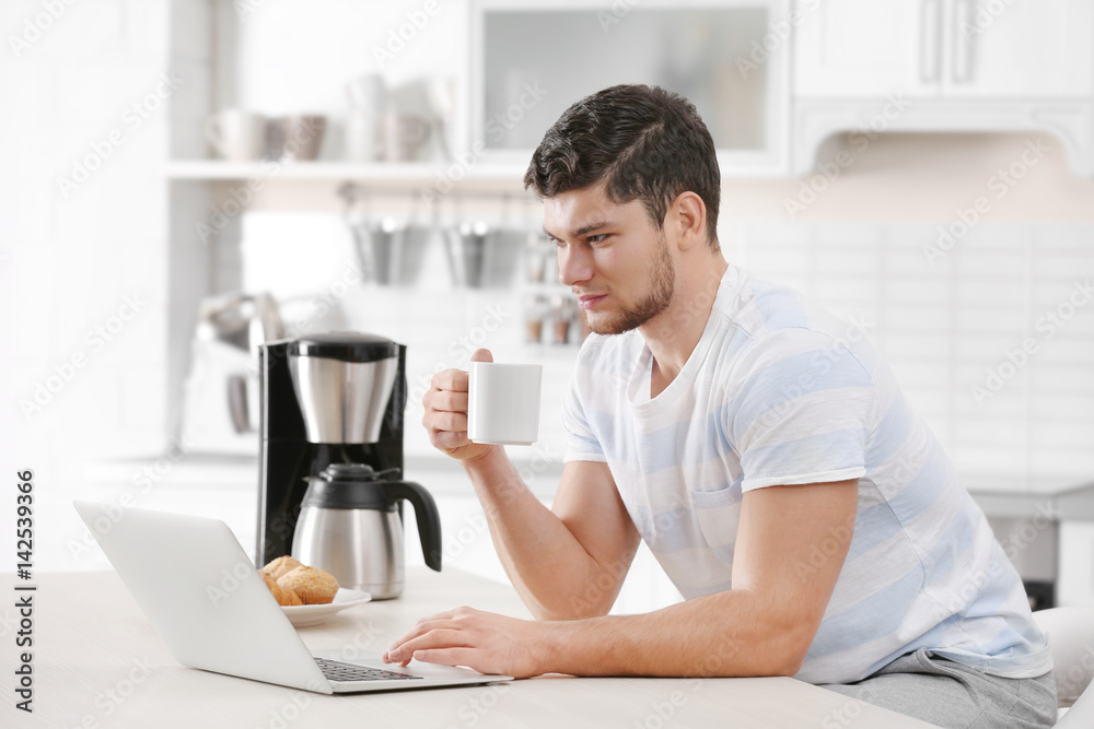 Handsome young man drinking coffee at home Handsome young man drinking coffee at home