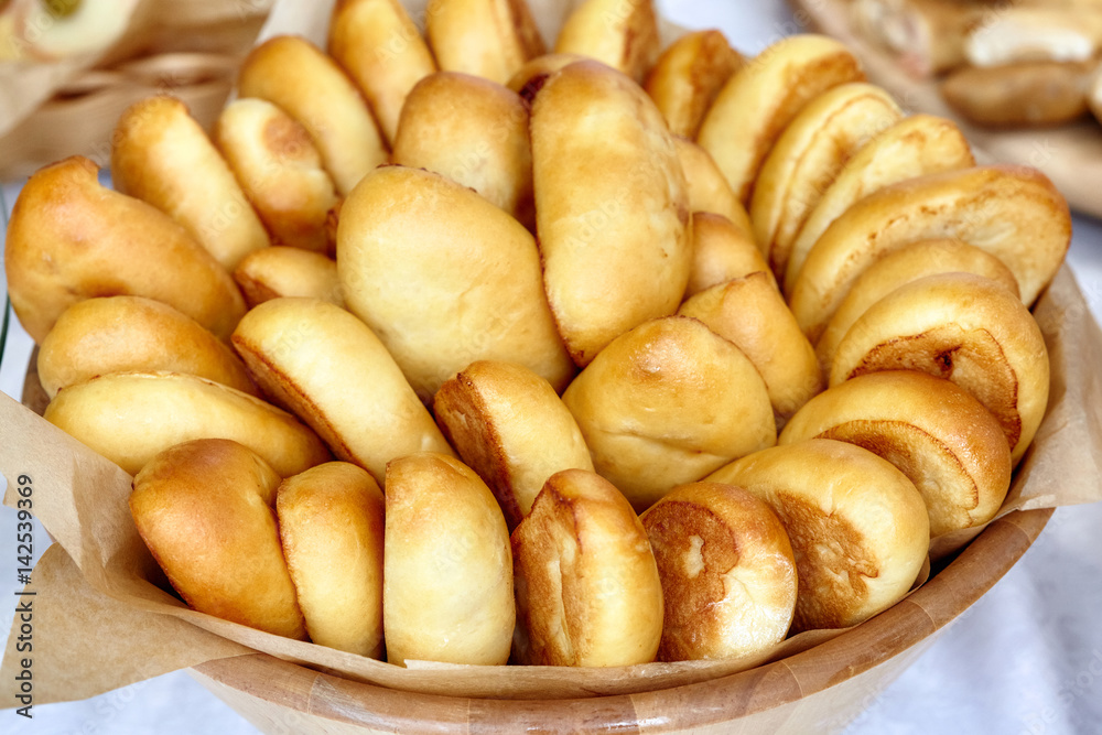 Bowl of oven fresh baked patties, russian pirozhki Bowl of oven fresh baked patties, russian pirozhki
