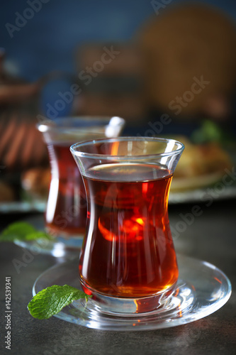 Turkish tea in traditional glasses on table closeup
