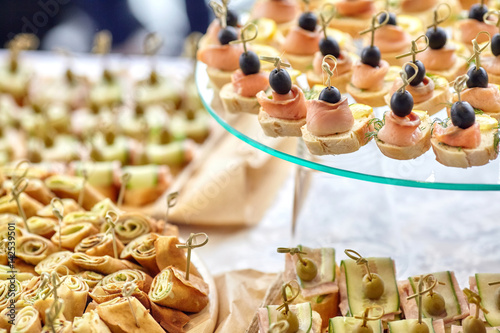 Catering of canape with olives, lemon and salmon