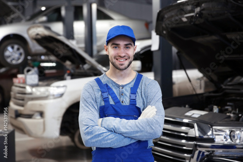 Young mechanic standing in ...
