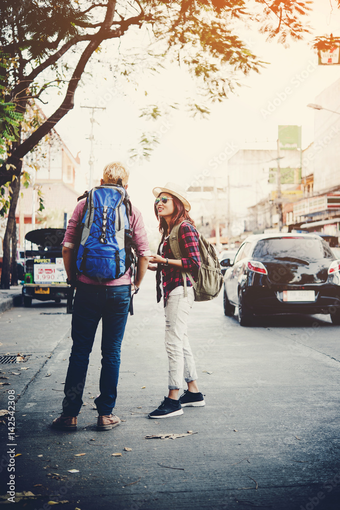 Couple on holiday walking through urban city to traveling. Travel concept. Couple on holiday walking through urban city to traveling. Travel concept.