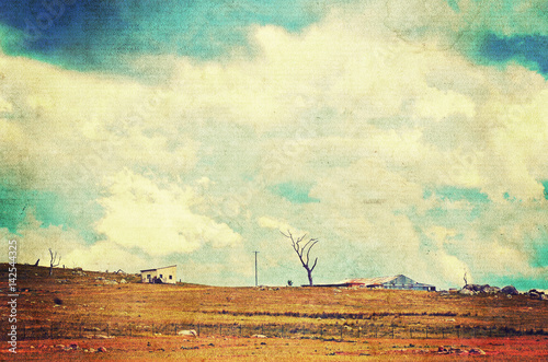 Fototapeta Naklejka Na Ścianę i Meble -  Storm clouds approaching over farmland in the New South Wales countryside, Australia. Grunge, aged paper textured image. 