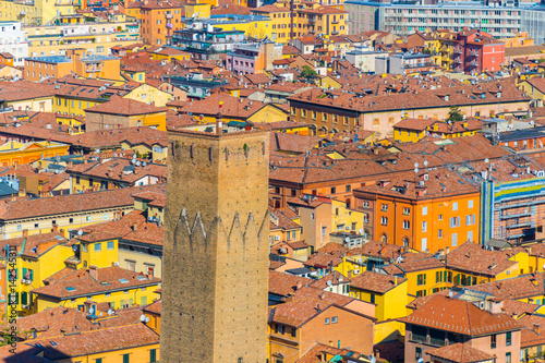 The Prendiparte Tower (also known as Coronata Tower) with a rooftop background of Bologna, Italy photo