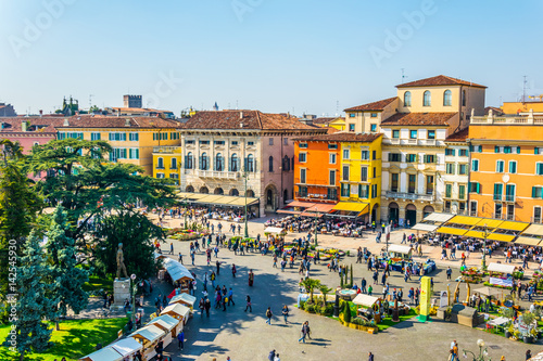 People are strolling among flower stands during Saturday market on the piazza bra in the Italian city Verona photo