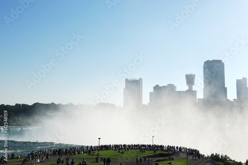 mist from Niagara Falls in the sky before city skyline © nd700