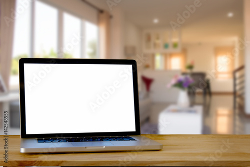 Mock up Blank screen laptop on wood top table and blurred living room background. for Procuct display montage.
