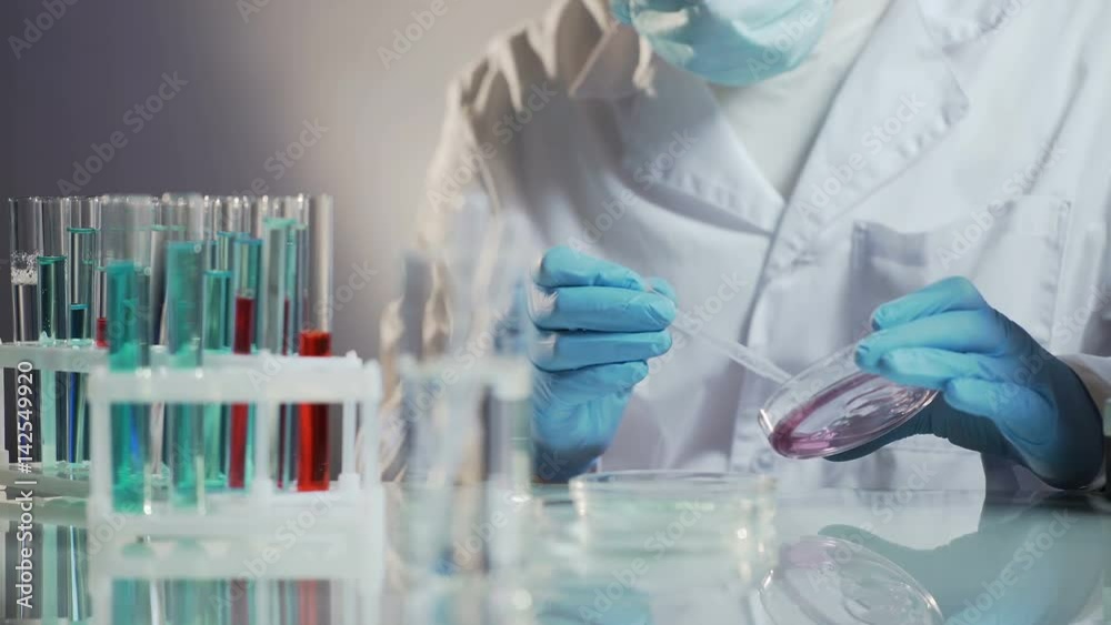 Assistant of cosmetic lab preparing universal cosmetic agent to add into creams Assistant of cosmetic lab preparing universal cosmetic agent to add into creams