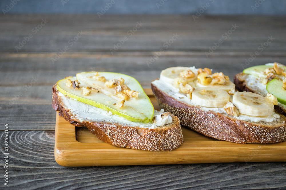 Sweet sandwiches  rye bread  ripe fruit pear banana Apple , healthy Breakfast