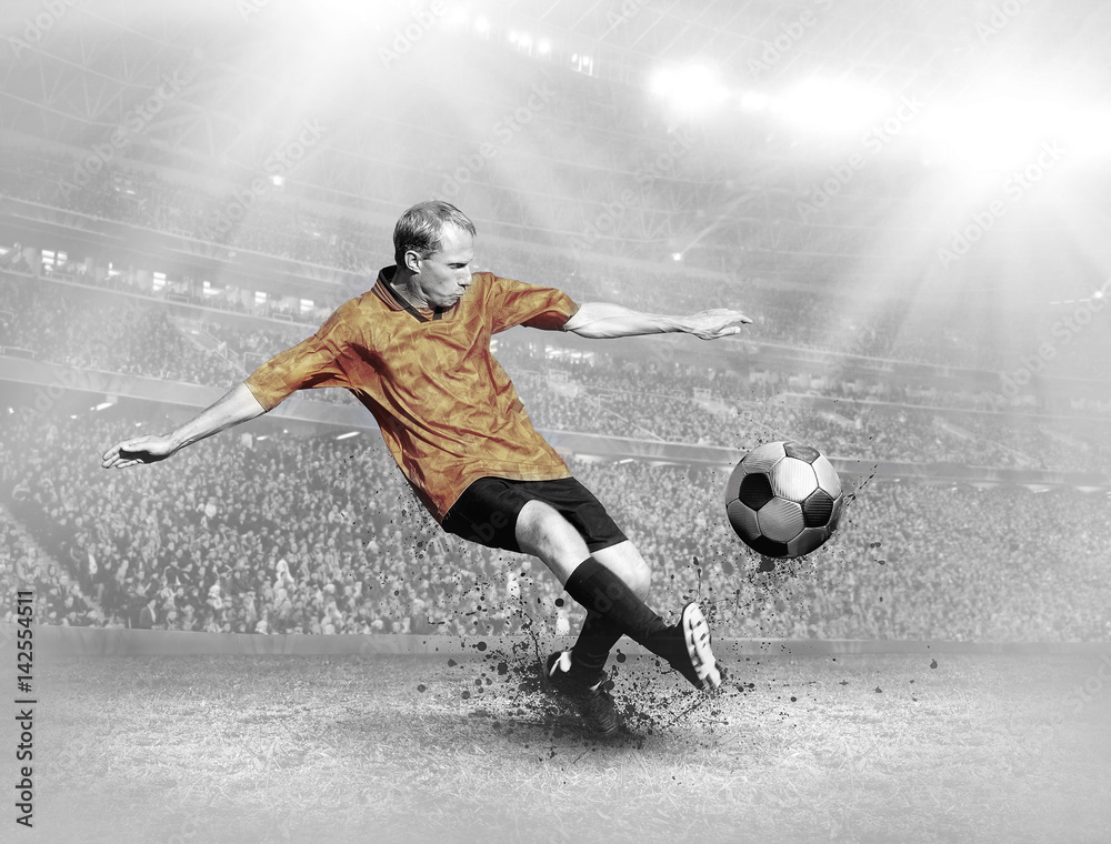Naklejka premium Soccer player with ball in action on field of stadium