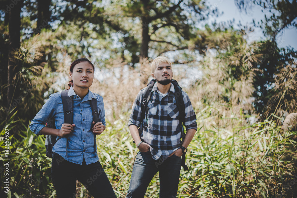 Couple hiking through forest to the mountaintop. Couple hiking through forest to the mountaintop.