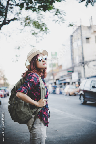 Happy hipster young woman carry backpack, Travel tourist woman with backpack outdoors during holidays. Women lifestyle concept.