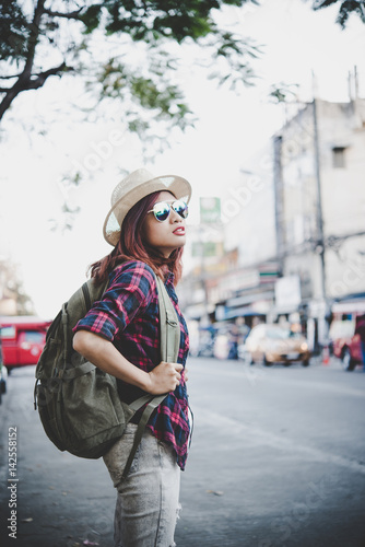 Happy hipster young woman carry backpack, Travel tourist woman with backpack outdoors during holidays. Women lifestyle concept.