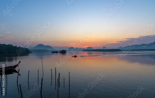 Beautiful sunrise landscape view of fisherman and wooden boat in early morming at Samchong-tai fishing village in Phang-Nga,Thailand