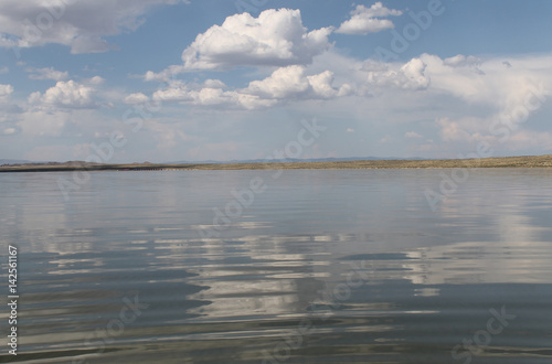 Fototapeta Naklejka Na Ścianę i Meble -  the sky reflected in the water, deserted beach lake, summer sky, nature, blue cloud,