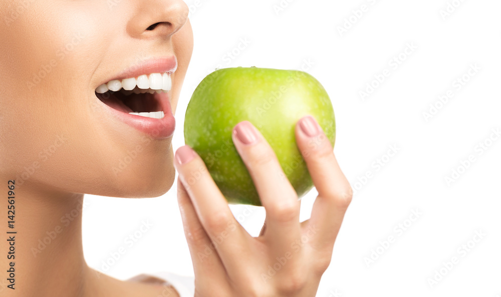 Healthy white teeth close up with an apple, isolated on white background Healthy white teeth close up with an apple, isolated on white background