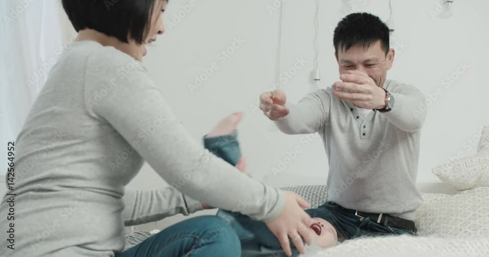 slow motion, a young Asian couple with a little girl in the bedroom, birth of a baby in the family slow motion, a young Asian couple with a little girl in the bedroom, birth of a baby in the family