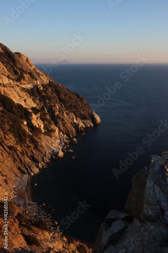 Cliffs in the island of Elba and Montecristo island on the horizon
