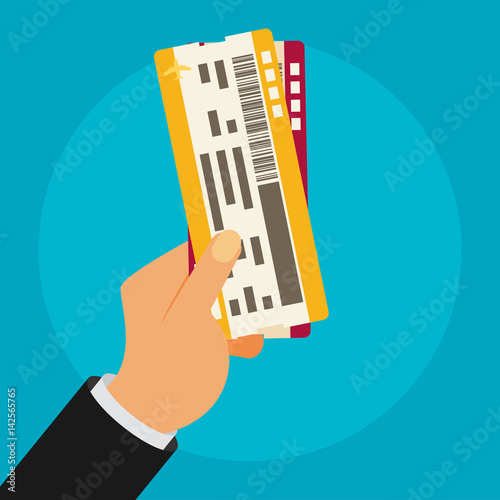 Hand holding boarding pass tickets.