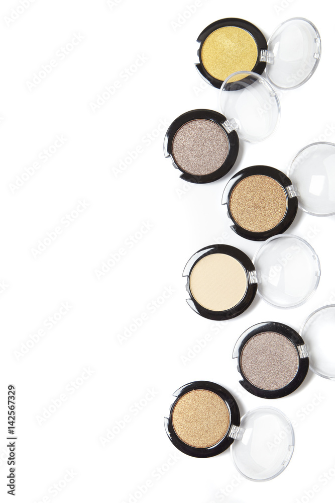 Assorted eye shadow make up compacts arranged to form a page border, and isolated on a white background Assorted eye shadow make up compacts arranged to form a page border, and isolated on a white background