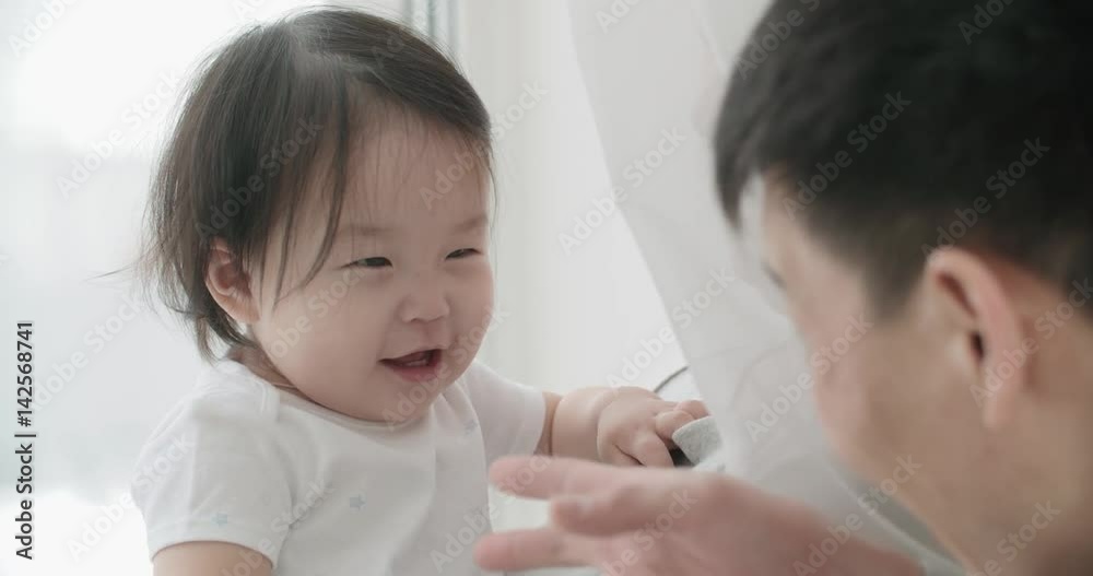 slow motion, little cheerful Asian girl playing with her parents ,moments of happiness in the family slow motion, little cheerful Asian girl playing with her parents ,moments of happiness in the family
