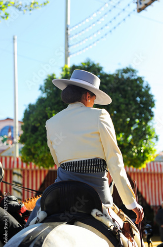 Spanish woman on horseback at the fair, Feast in Spain photo