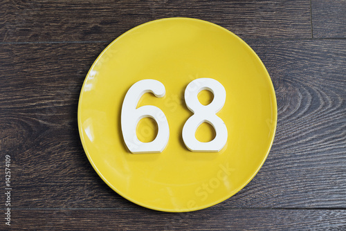 The number sixty-eight on the yellow plate. photo