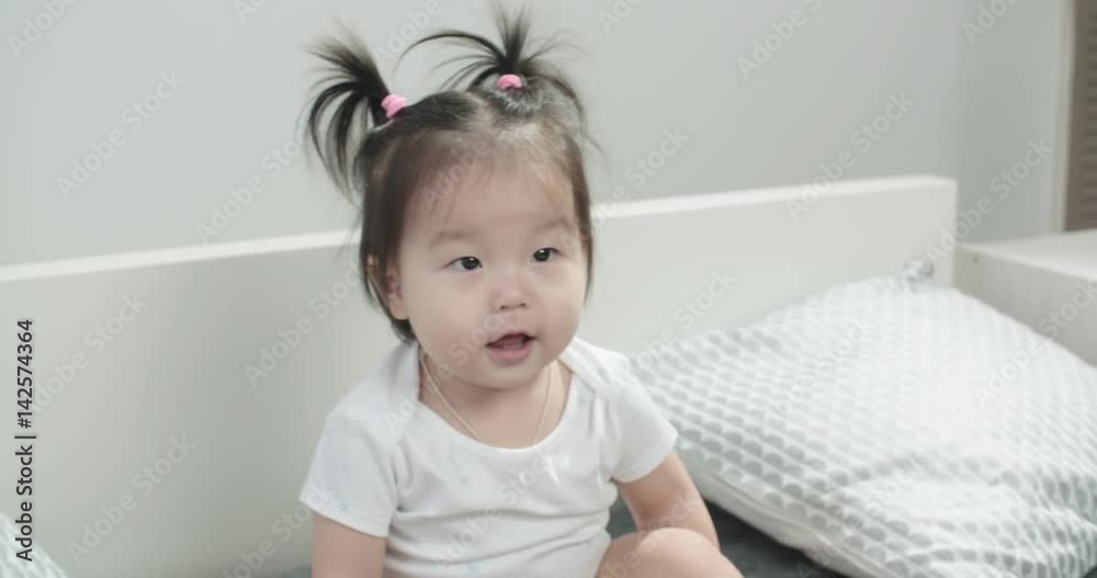 slow motion, close-up, babe Asian 1 year,having fun on the bed in the room , emotionally expresses joy slow motion, close-up, babe Asian 1 year,having fun on the bed in the room , emotionally expresses joy