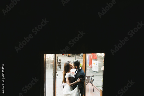 The lovely couple in love embracing in the room