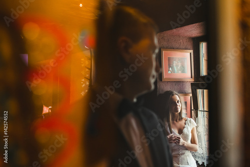 The bride and groom standing in the room © andriychuk
