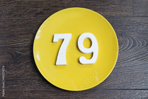 The number seventy-nine on the yellow plate.