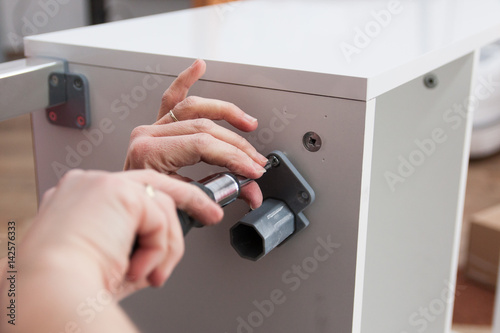 assembling bathroom furniture with screwdriver