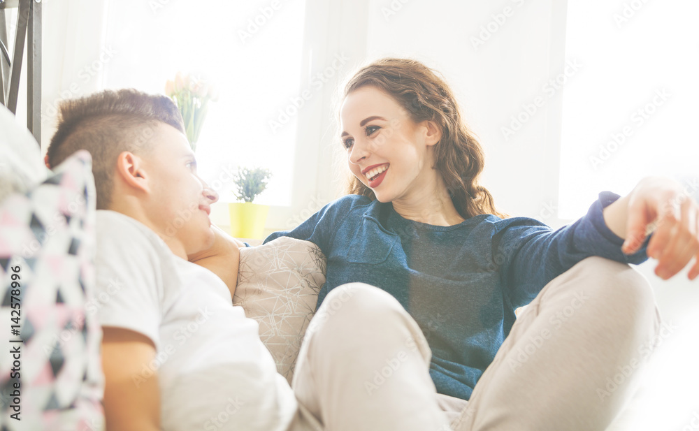Loving couple looking at each other and smiling home interior