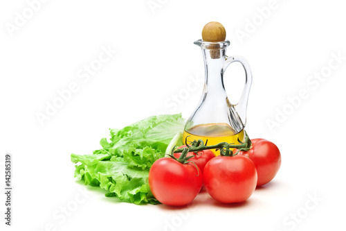 Tomato, lettuce salad and jug of vegetable oil oil isolated