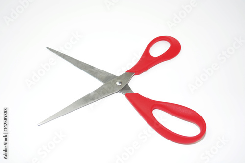 Red metal scissors on the white background