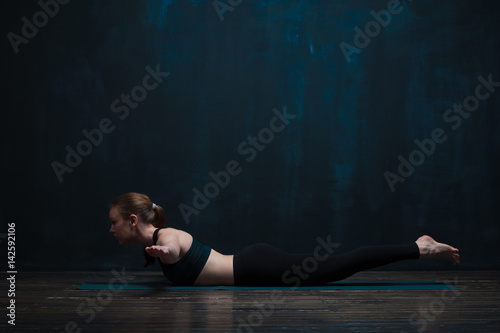 Fit young woman wearing sportswear doing yoga